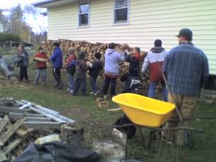 Cubs stacking fire wood for Ken Margeson